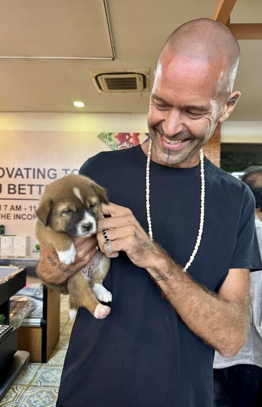 Stephan Mairesse holding a small puppy